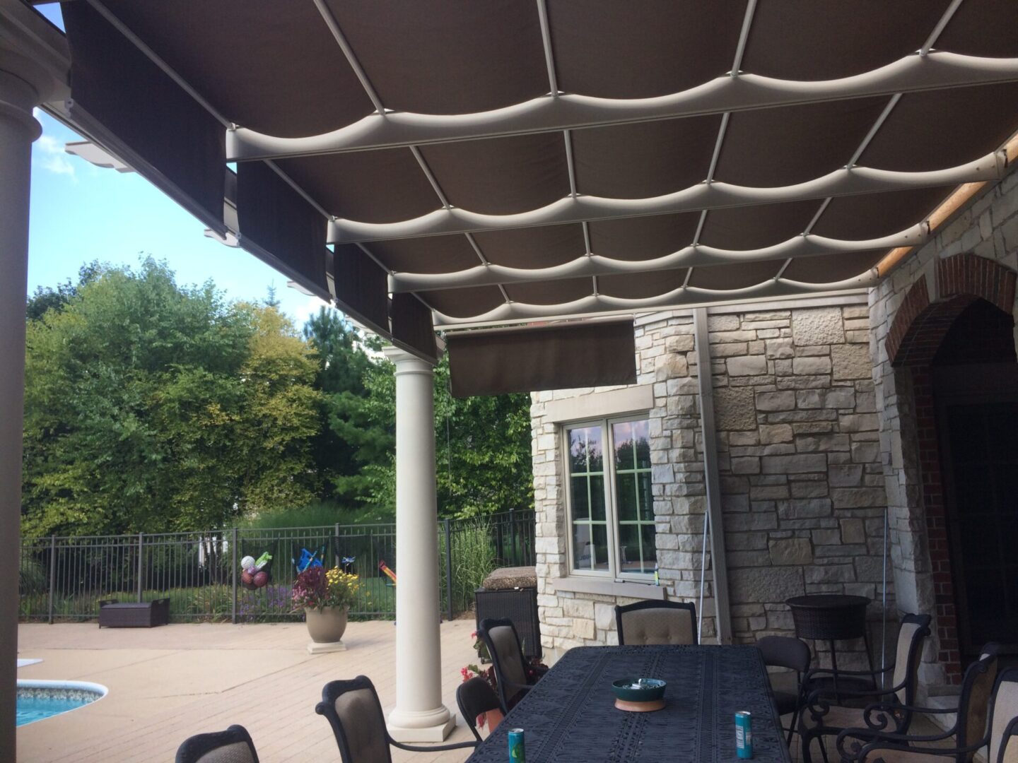 A patio with an outdoor table and chairs.