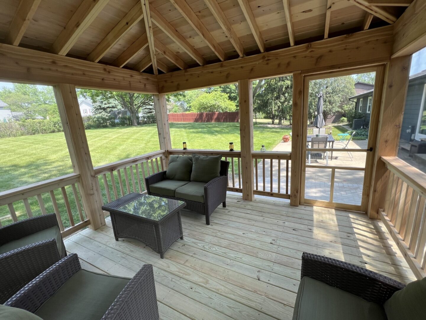 A wooden deck with furniture and a table