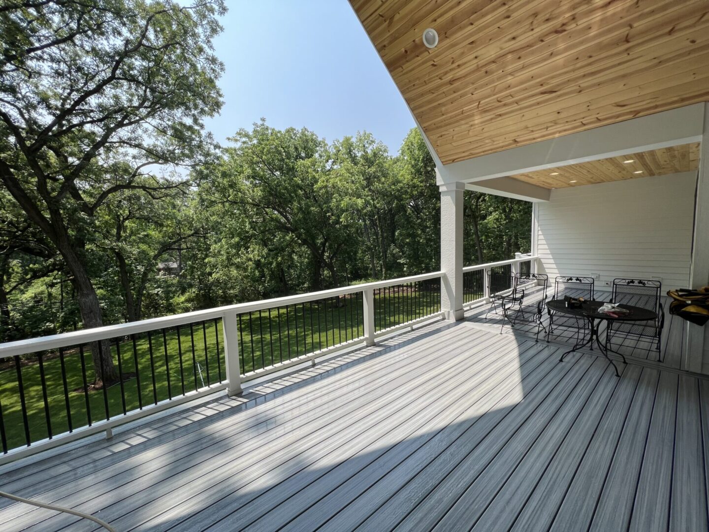 A large deck with chairs and tables on it