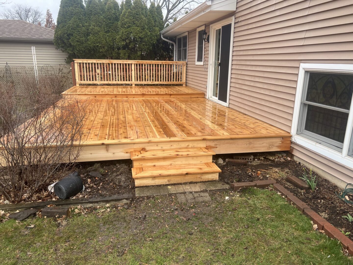 A wooden deck with steps leading to the back of it.