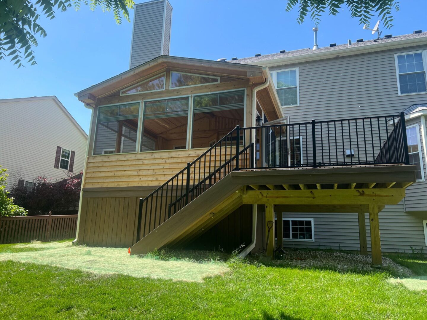 A house with stairs leading to the back deck.