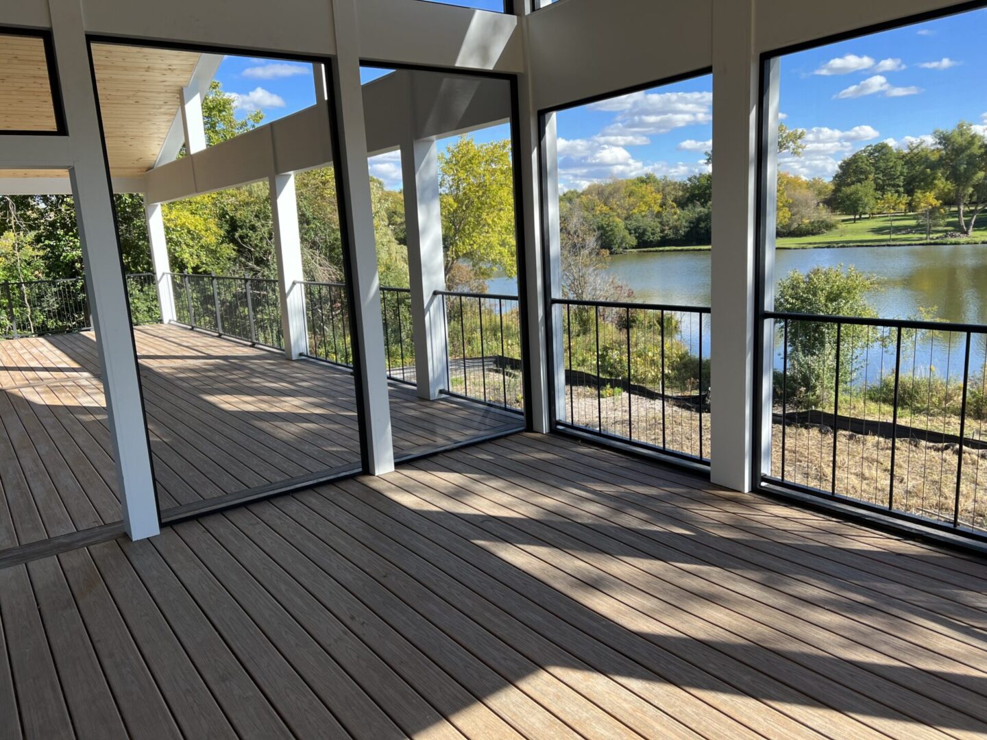 A large open deck with glass doors and windows.