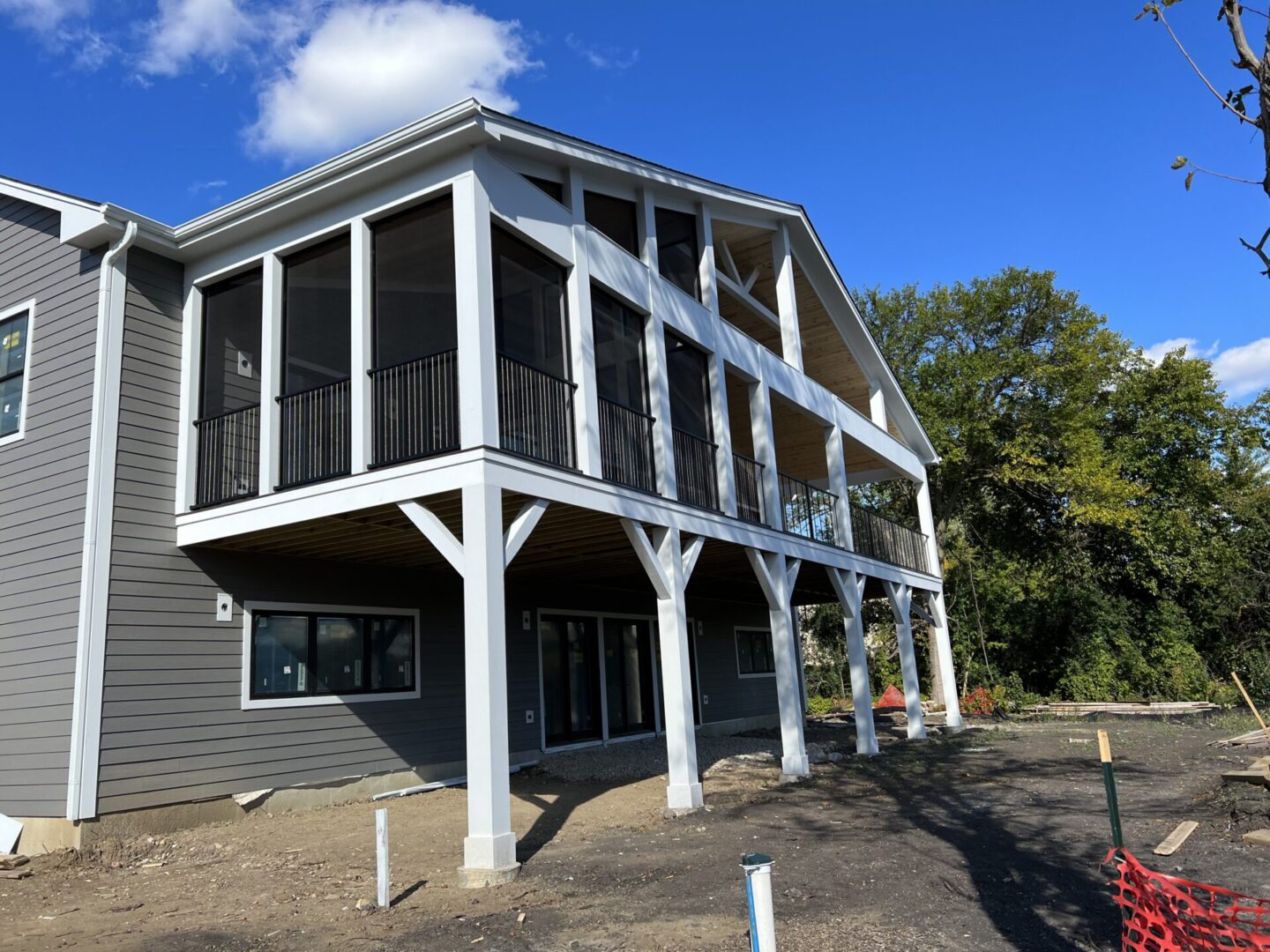 A building with a porch and balcony on the side of it.