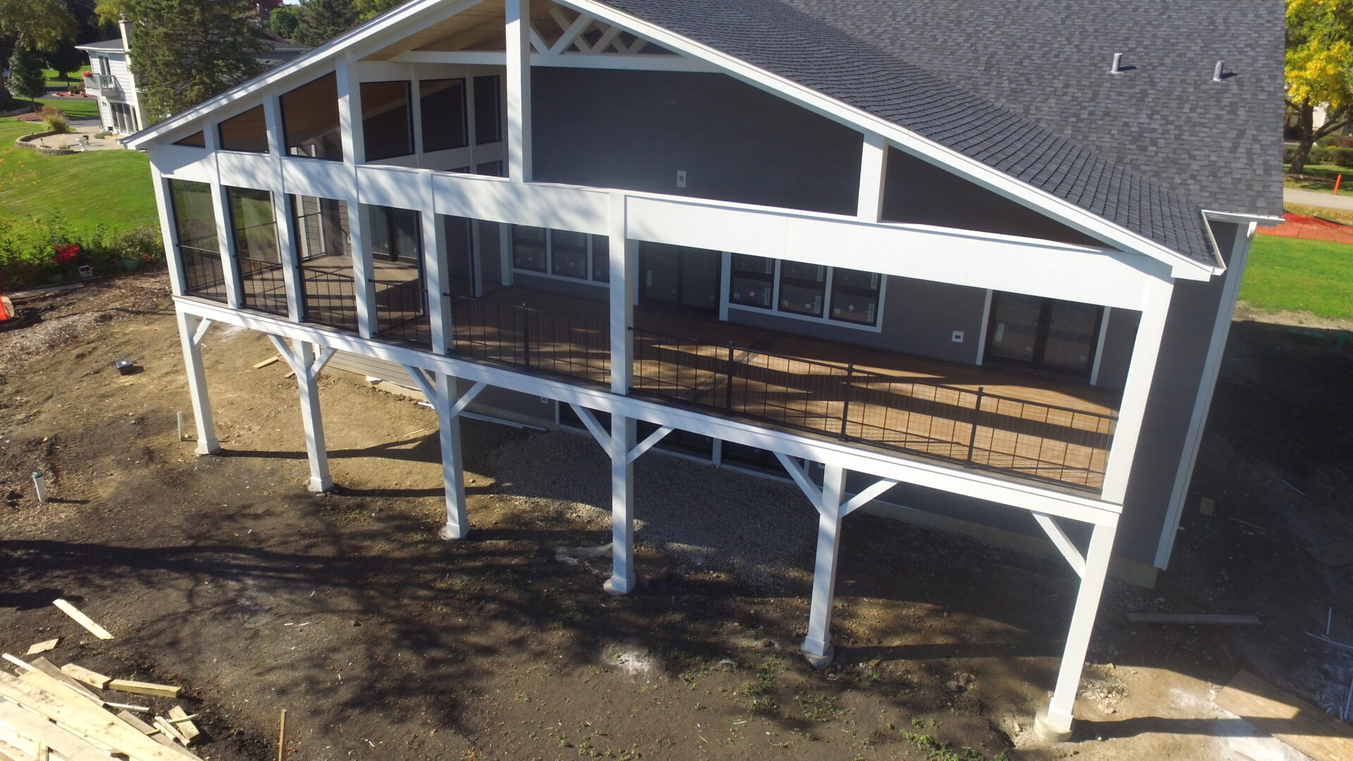 A large deck with a railing and a wooden platform.